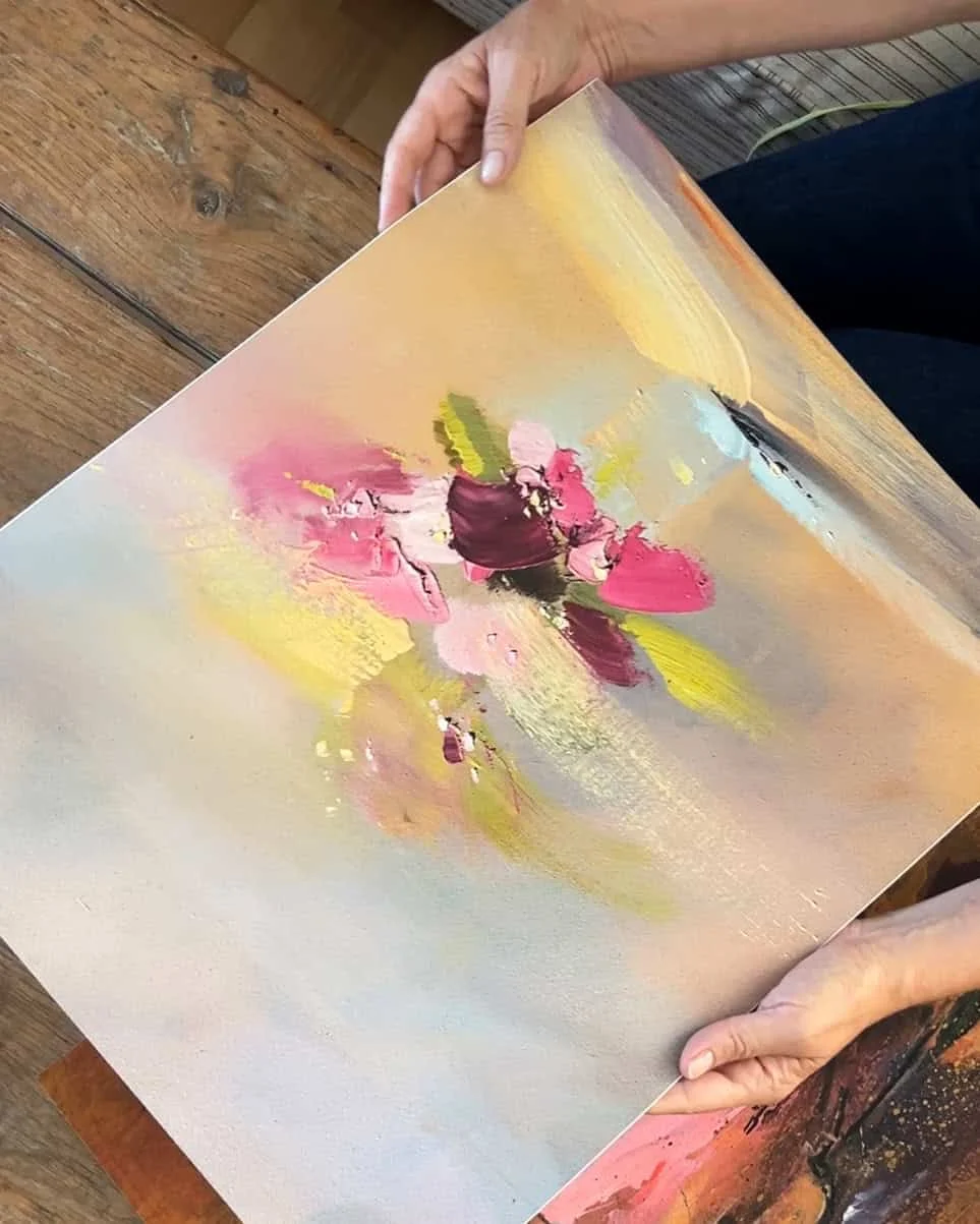 Abstract floral art with pink, yellow, and green colors on canvas.