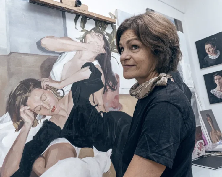 The Funky Curator painting artist at work in studio Artist creating a contemporary portrait painting in art studio.